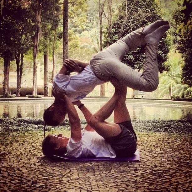 Satori Silva sitting on a blue puzzle mat with his arms wrapped around his legs