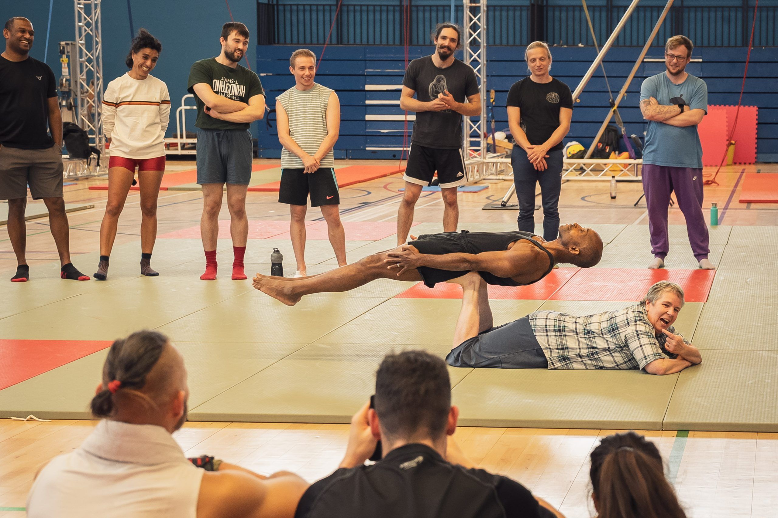 Eugene & Jessie of AcroYogaMontreal demonstrate belly basing back plank in front of LAC 2025 Teachers